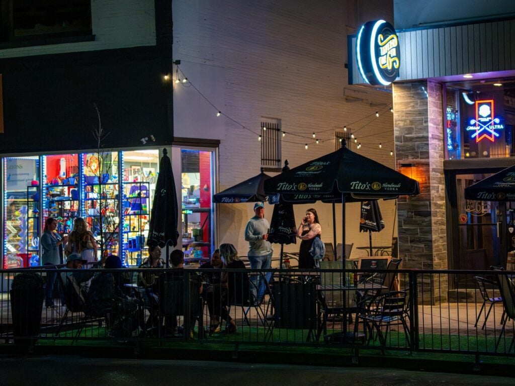Diners on a downtown Kenosha patio at night, photographed by TMC Marketing for Go Downtown Kenosha